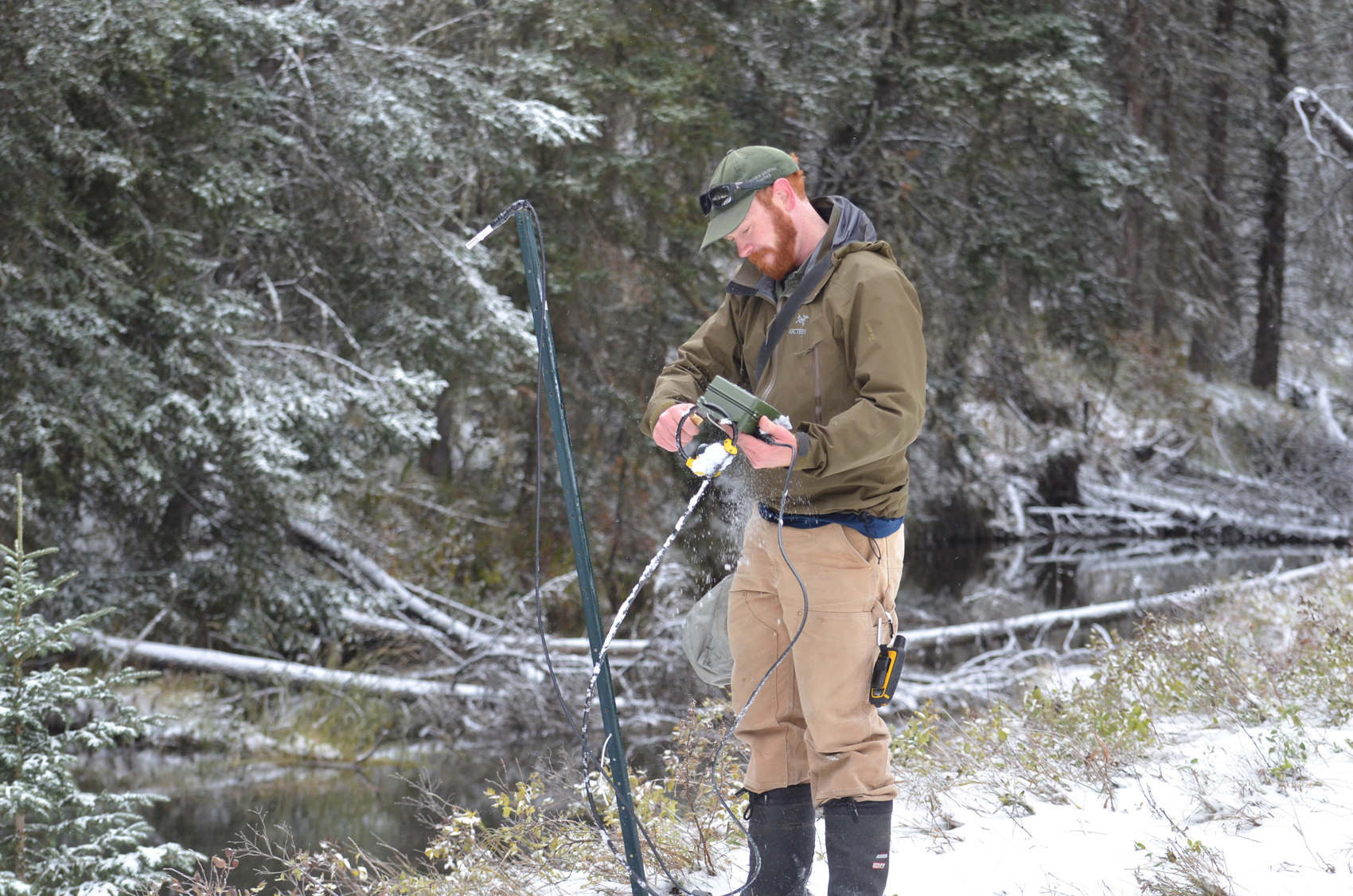 Adam Sprott checking bat detectors in on a snowy day.