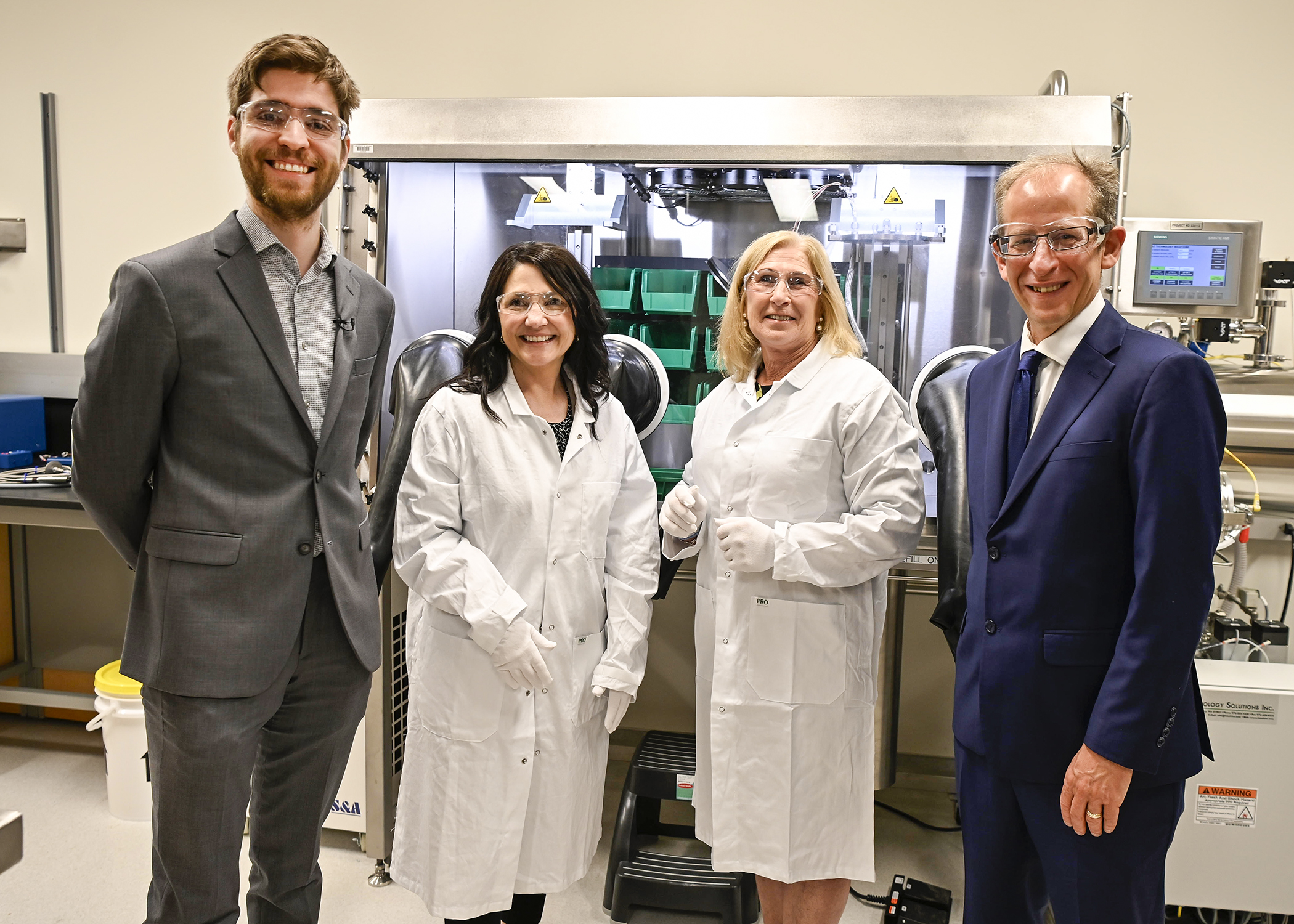 Dr. Arthur Situm with Kari Harvey, Minister Young, and President Keshen in Situm's lab at the U of R. (Photo Courtesy of Innovation Saskatchewan)