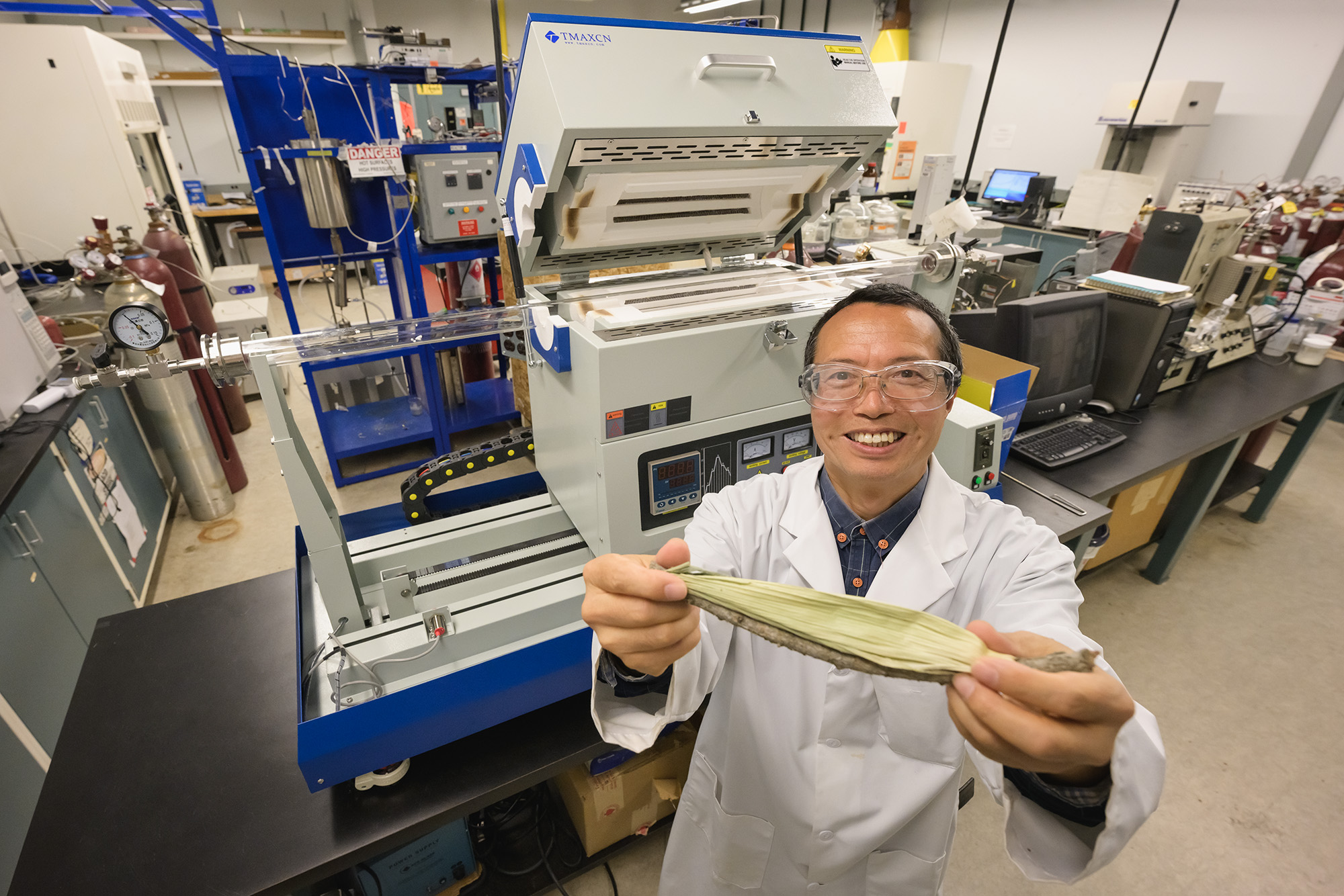 Dr. Yong X. Gan in his U of R lab with a corn cob before it has been hydrothermally carbonized. (Photo by Trevor Hopkin)