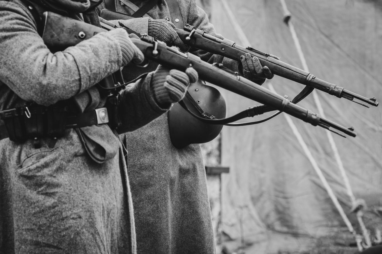 Two German soldiers of the Second World War with rifles in their hands ready to fire. Black and white photo